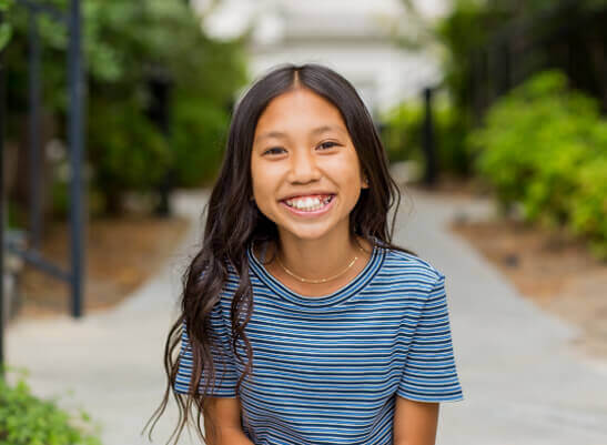 Young girl smiling outside - DeBary, FL pediatric dentist