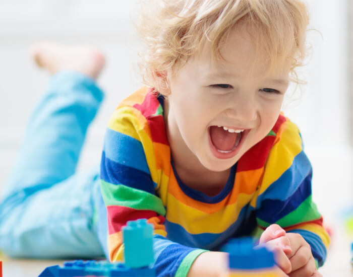 Child smiling with toys